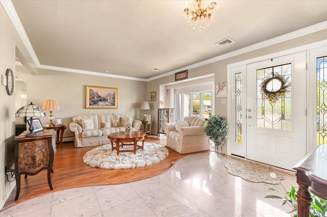 foyer entrance featuring crown molding, a baseboard heating unit, and a chandelier