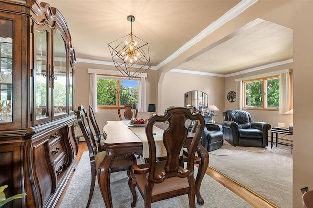dining room featuring a chandelier, crown molding, and wood finished floors