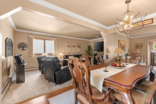 dining area featuring light wood-type flooring, baseboard heating, crown molding, a baseboard radiator, and a chandelier
