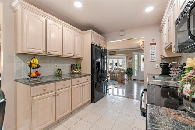 kitchen with black appliances, a sink, backsplash, recessed lighting, and light tile patterned floors