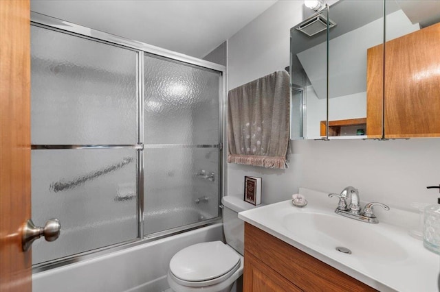 bathroom with shower / bath combination with glass door, vanity, and toilet