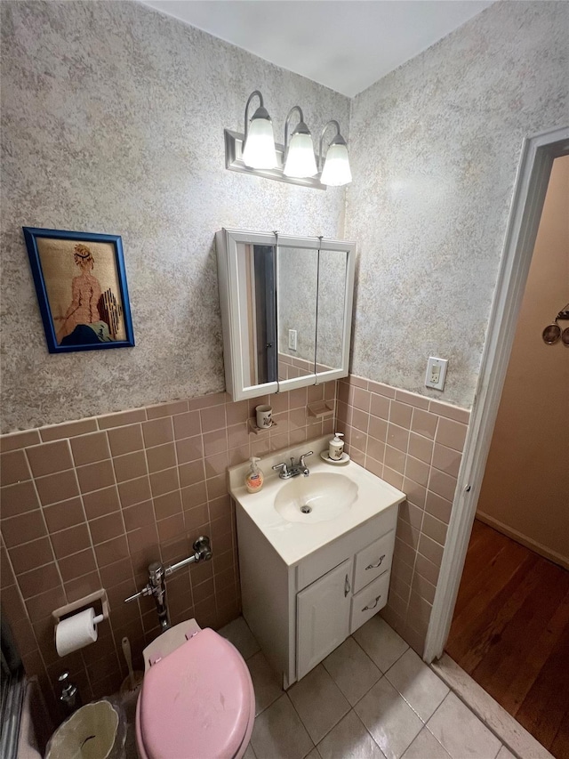 86-10 151st Ave Unit 4G, Howard Beach, NY 11414 - bathroom featuring tile walls, tile patterned floors, vanity, toilet, and wallpapered walls