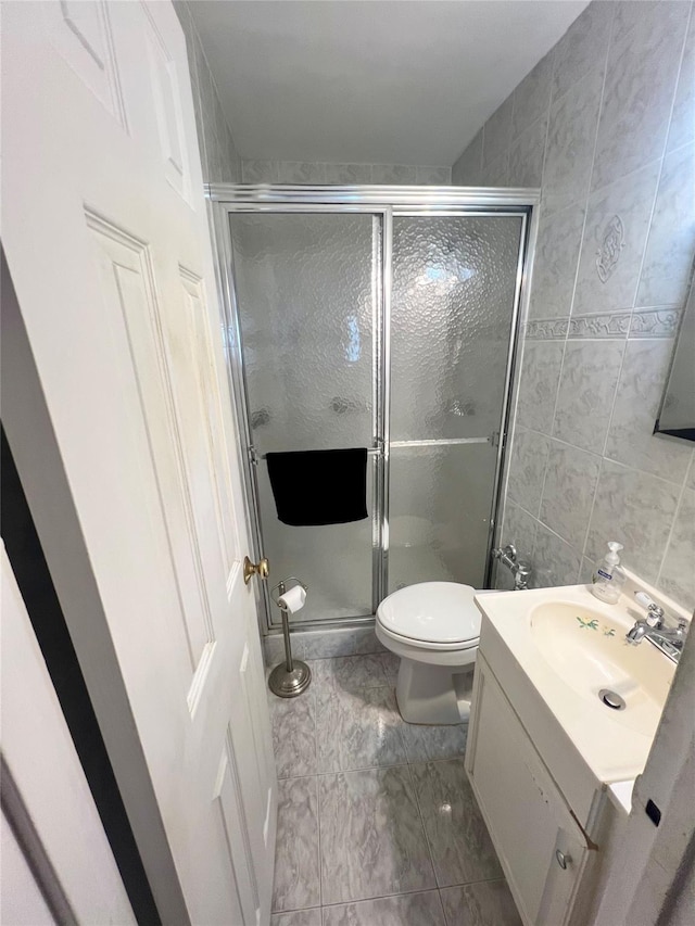 86-10 151st Ave Unit 4G, Howard Beach, NY 11414 - bathroom featuring a shower stall, vanity, toilet, and marble look tile flooring