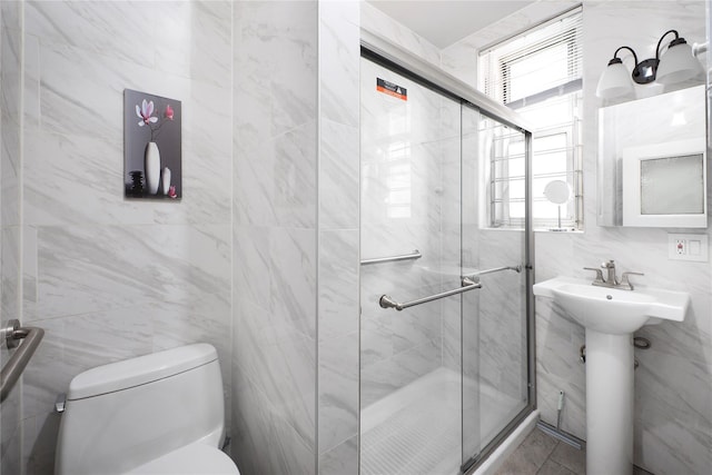 35-31 78th St Unit 3, Jackson Heights, NY 11372 - full bath with tile walls, plenty of natural light, a stall shower, toilet, and a sink
