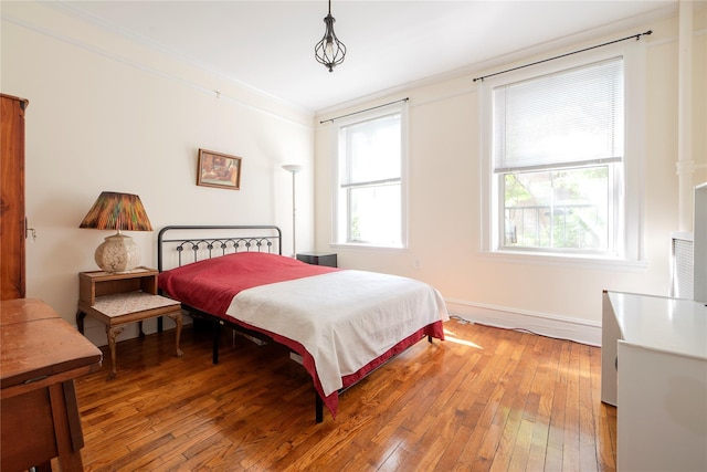35-31 78th St Unit 3, Jackson Heights, NY 11372 - bedroom featuring light wood-style floors, ornamental molding, and baseboards