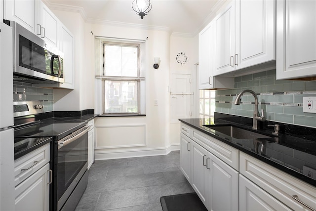 35-31 78th St Unit 3, Jackson Heights, NY 11372 - kitchen with stainless steel appliances, a sink, white cabinets, ornamental molding, and decorative backsplash