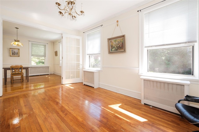 35-31 78th St Unit 3, Jackson Heights, NY 11372 - interior space featuring radiator, a chandelier, and light wood-style flooring