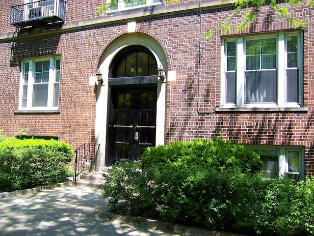 35-31 78th St Unit 3, Jackson Heights, NY 11372 - property entrance featuring brick siding, french doors, and a balcony