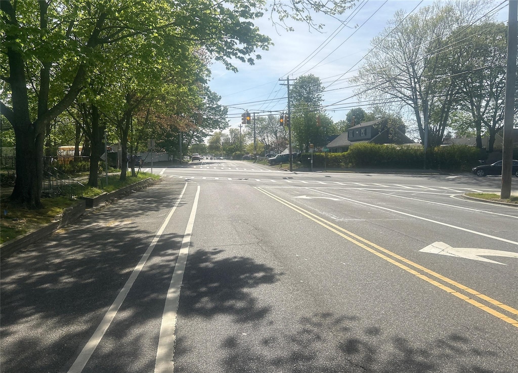 view of asphalt road featuring traffic lights