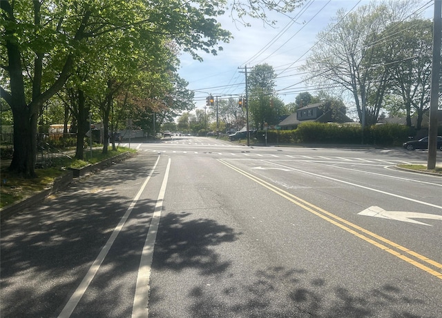 view of asphalt road featuring traffic lights