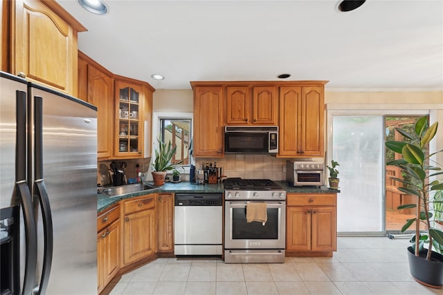 539 Keller Ave, Elmont, NY 11003 - kitchen featuring appliances with stainless steel finishes, a sink, dark countertops, decorative backsplash, and ornamental molding