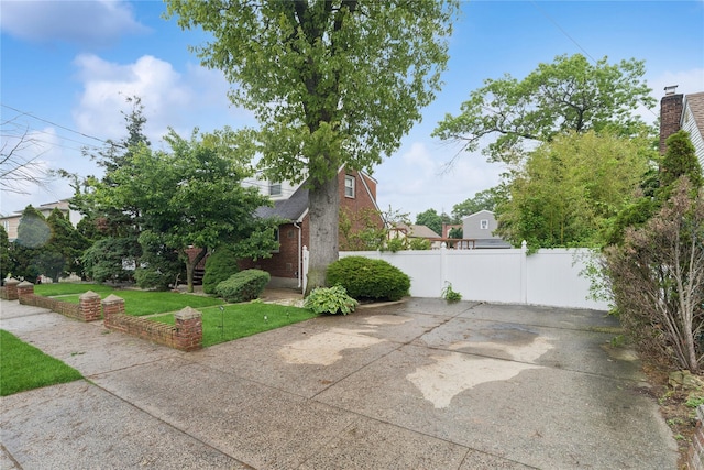539 Keller Ave, Elmont, NY 11003 - view of side of property featuring brick siding, a patio area, and roof with shingles