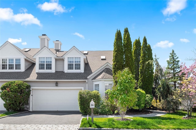 58 Roundtop Rd, Yonkers, NY 10710 - view of front of home with a shingled roof, asphalt driveway, and a garage