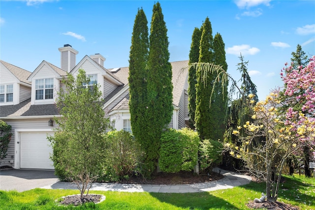 58 Roundtop Rd, Yonkers, NY 10710 - view of front of home with a shingled roof, asphalt driveway, and an attached garage