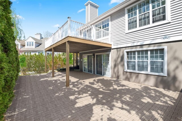58 Roundtop Rd, Yonkers, NY 10710 - back of property featuring a wooden deck, a patio, and a chimney