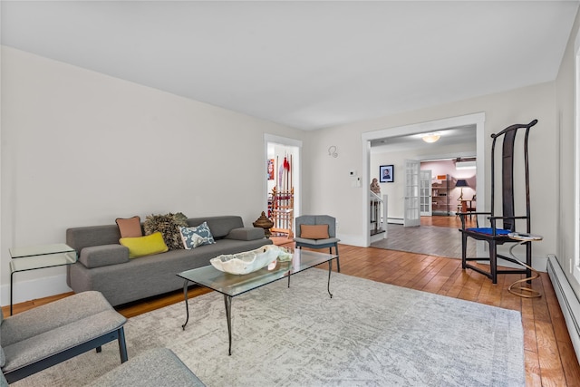 5 Bellwood Ln, Cornwall On Hudson, NY 12520 - living room featuring baseboard heating, hardwood / wood-style flooring, french doors, and baseboards