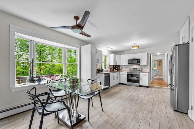 5 Bellwood Ln, Cornwall On Hudson, NY 12520 - dining area with healthy amount of natural light, ceiling fan, and light wood finished floors