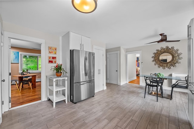 5 Bellwood Ln, Cornwall On Hudson, NY 12520 - kitchen featuring freestanding refrigerator, light wood-style floors, white cabinets, a ceiling fan, and light countertops