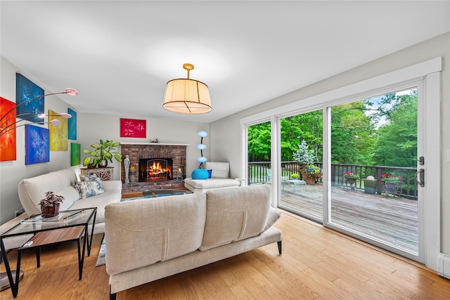 5 Bellwood Ln, Cornwall On Hudson, NY 12520 - living room featuring plenty of natural light, a brick fireplace, and wood finished floors