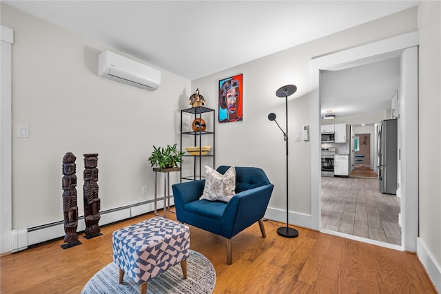 5 Bellwood Ln, Cornwall On Hudson, NY 12520 - living area featuring a wall mounted AC, light wood finished floors, baseboard heating, and baseboards