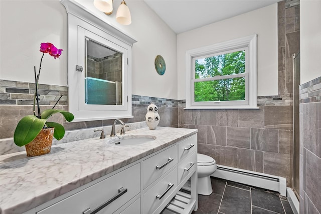 5 Bellwood Ln, Cornwall On Hudson, NY 12520 - full bathroom featuring a baseboard radiator, tile walls, vanity, a tile shower, and toilet