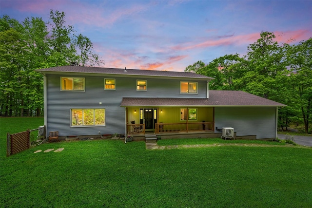 5 Bellwood Ln, Cornwall On Hudson, NY 12520 - back of property at dusk with covered porch, a lawn, and a shingled roof