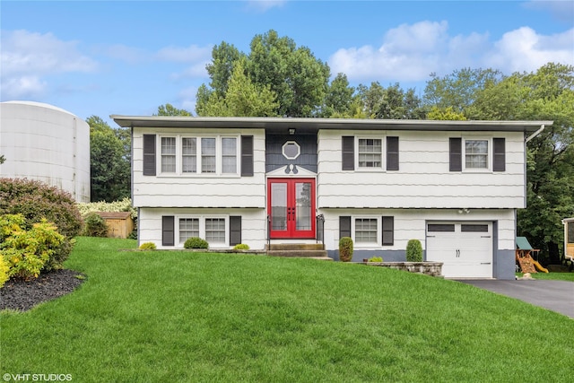split foyer home with french doors, a front lawn, a garage, and driveway