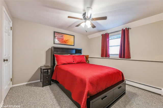 carpeted bedroom with baseboard heating, ceiling fan, and baseboards