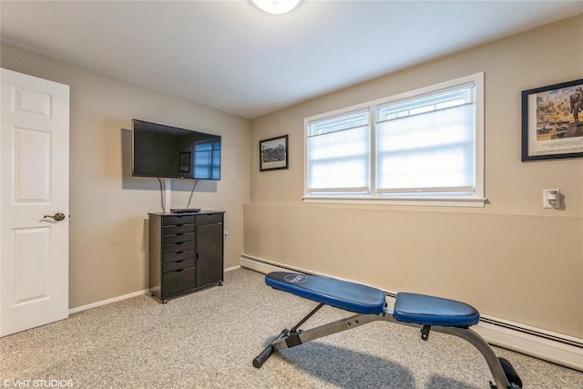 exercise area featuring a baseboard heating unit, carpet floors, and baseboards