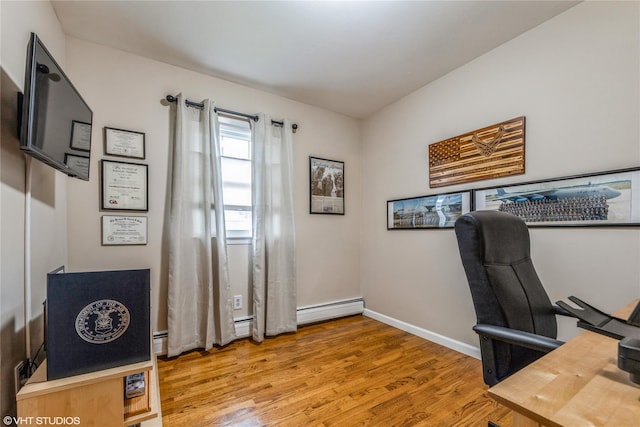 office space with wood finished floors and baseboards