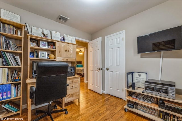 home office with light wood finished floors