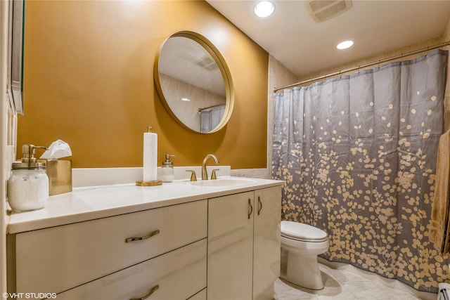 bathroom with toilet, tile patterned floors, vanity, recessed lighting, and a baseboard radiator