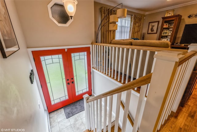 foyer entrance featuring french doors, crown molding, and stairway