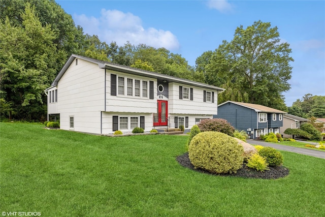 raised ranch featuring a front yard