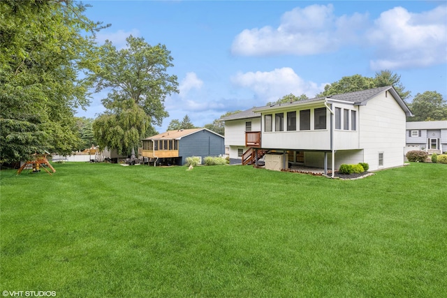 11 Sagamore Ave, Suffern, NY 10901 - back of property featuring a sunroom, a yard, a playground, and a shingled roof