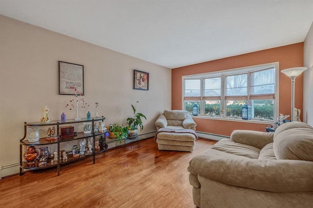 living area featuring baseboard heating and wood finished floors
