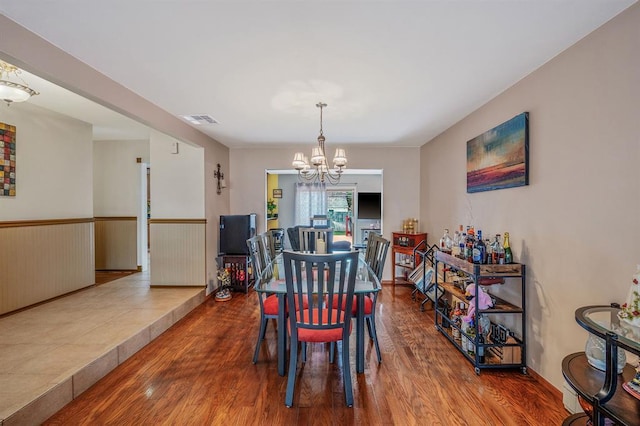 dining space featuring a chandelier and wood finished floors