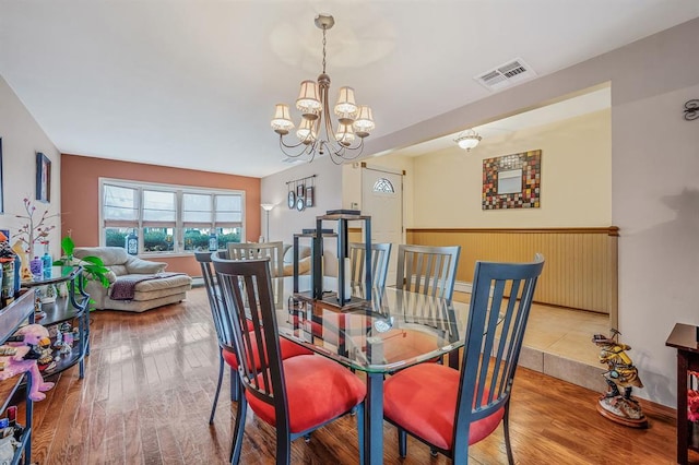 dining room with a chandelier and wood finished floors