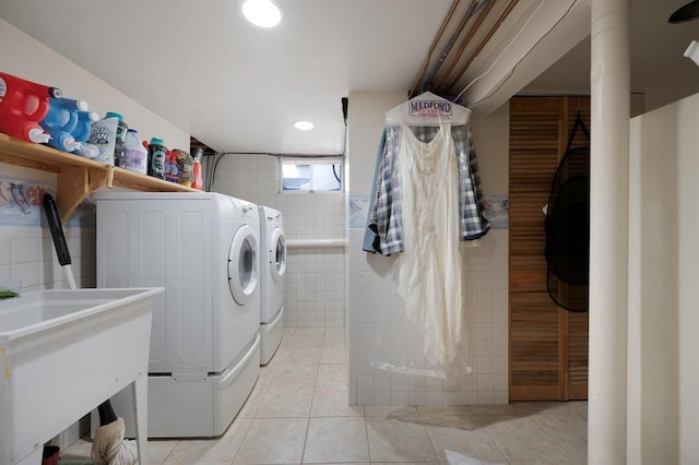 clothes washing area with separate washer and dryer, tile walls, light tile patterned floors, and recessed lighting