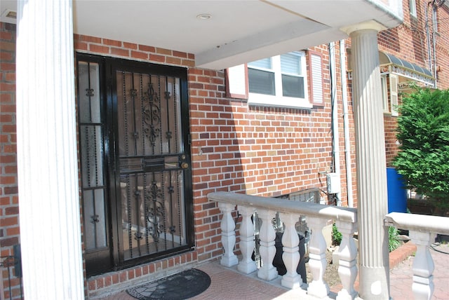 view of exterior entry with brick siding