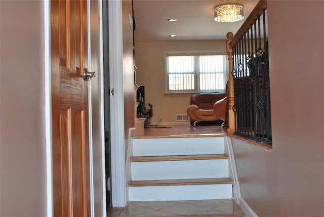 stairway featuring tile patterned flooring