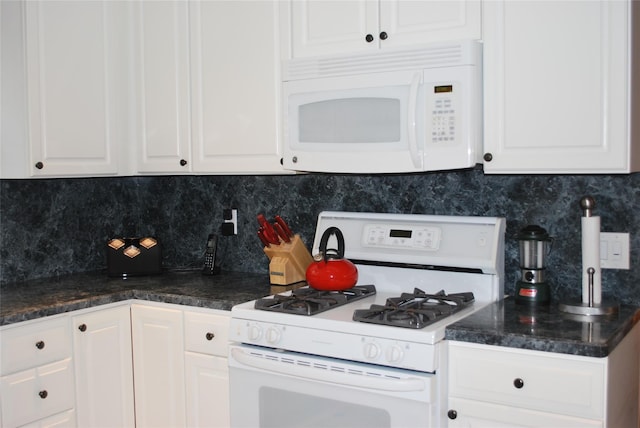 kitchen featuring white appliances, tasteful backsplash, and white cabinetry