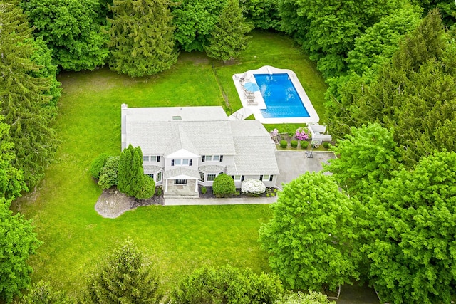 view of subject property with a pool