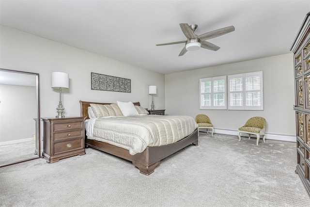 carpeted bedroom with baseboard heating, baseboards, and a ceiling fan