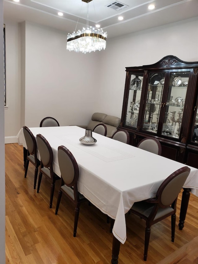 dining room featuring wood finished floors, recessed lighting, baseboards, and a chandelier
