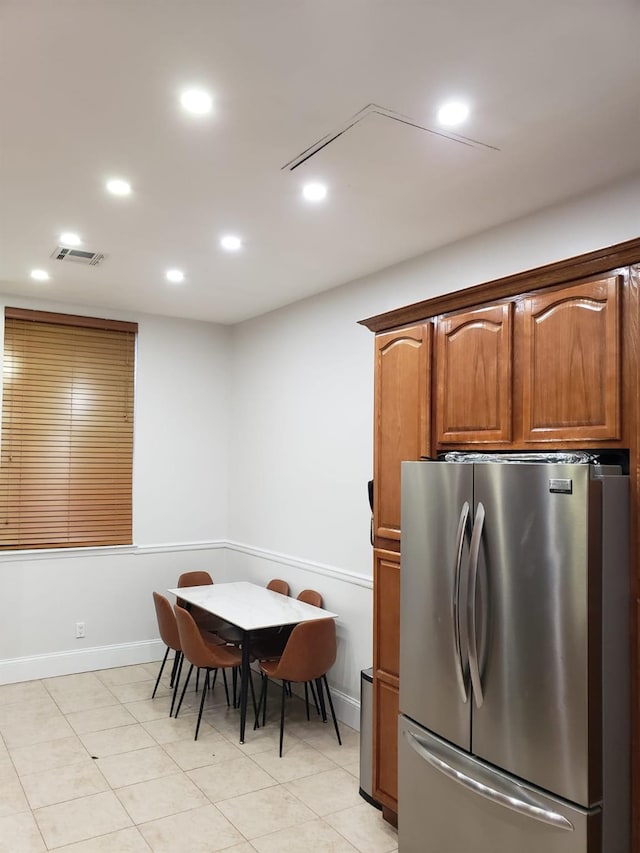 kitchen featuring freestanding refrigerator, recessed lighting, baseboards, and brown cabinets