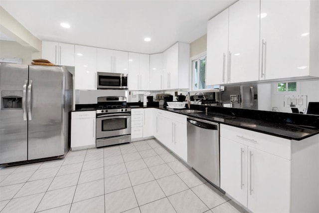 680 Corbalis Pl, Yonkers, NY 10703 - kitchen featuring stainless steel appliances, white cabinets, a sink, dark countertops, and recessed lighting