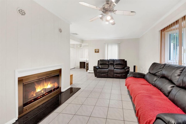 680 Corbalis Pl, Yonkers, NY 10703 - living room featuring healthy amount of natural light, ceiling fan, ornamental molding, a warm lit fireplace, and light tile patterned floors