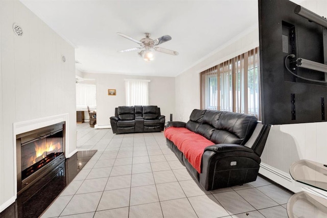 680 Corbalis Pl, Yonkers, NY 10703 - tiled living room with healthy amount of natural light, a ceiling fan, a glass covered fireplace, crown molding, and a baseboard heating unit