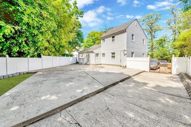 680 Corbalis Pl, Yonkers, NY 10703 - rear view of property with driveway, a patio, and a gate